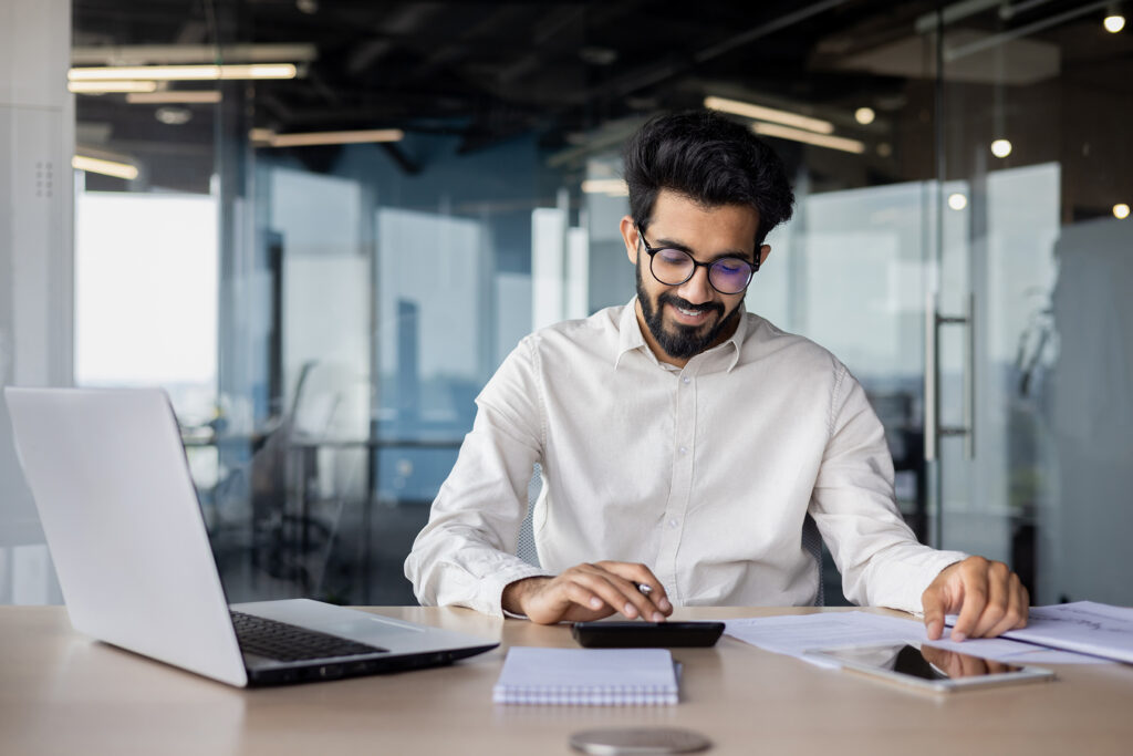 young male accountant working focused in office