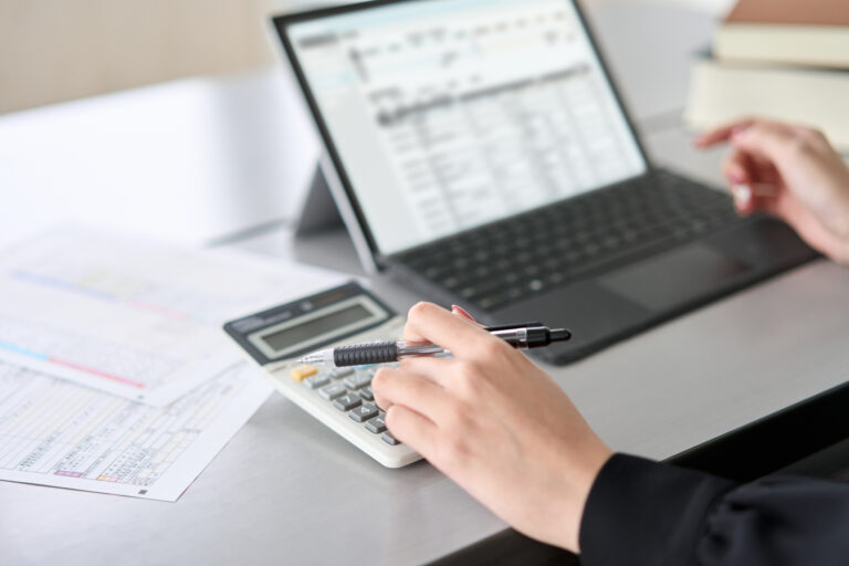 Woman entering journal entries in accounting software