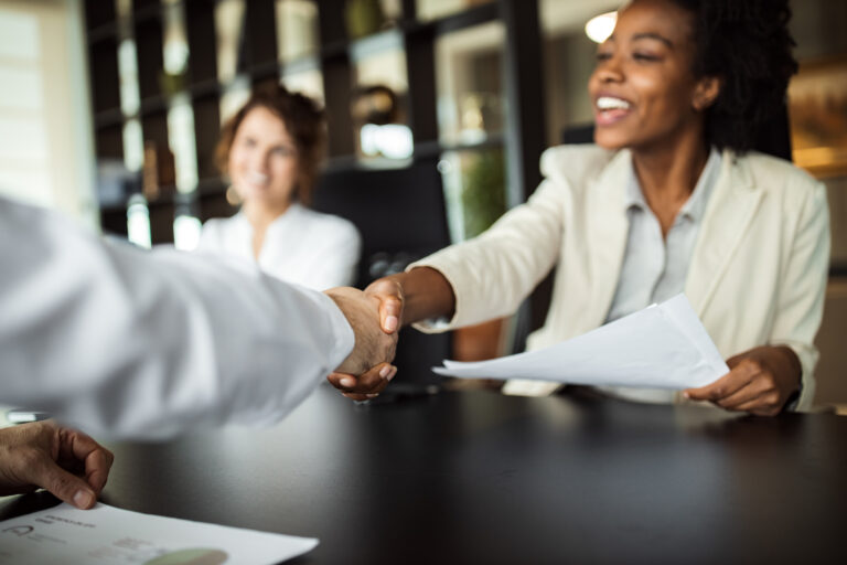 Business woman shaking hands with partner