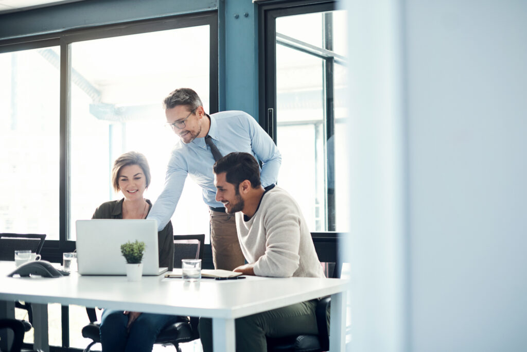 Team members using a laptop during a meeting