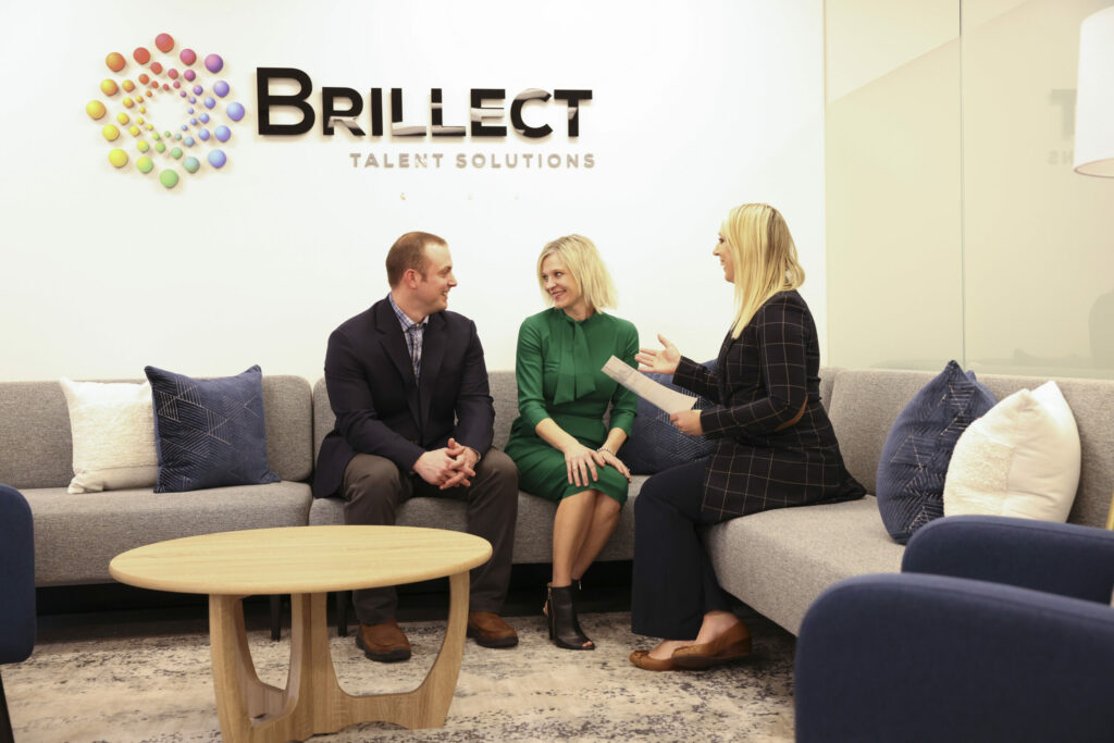 Three Brillect coworkers having a discussion in the Minneapolis office