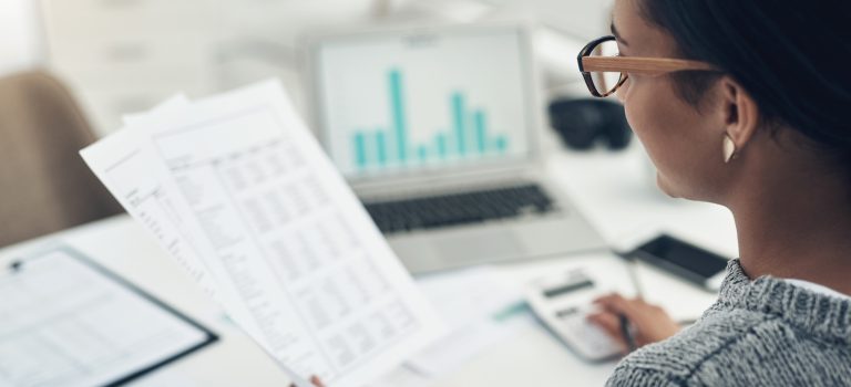 Closeup shot of an unrecognisable businesswoman calculating finances in an office businesswoman calculating finances