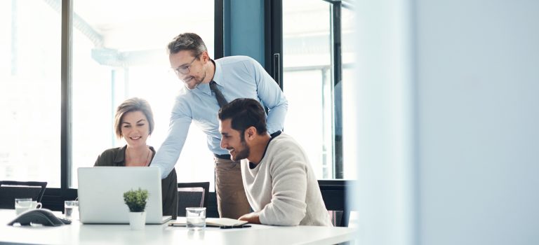 The kind of brainstorming that brilliant business is made of Team members using a laptop during a meeting